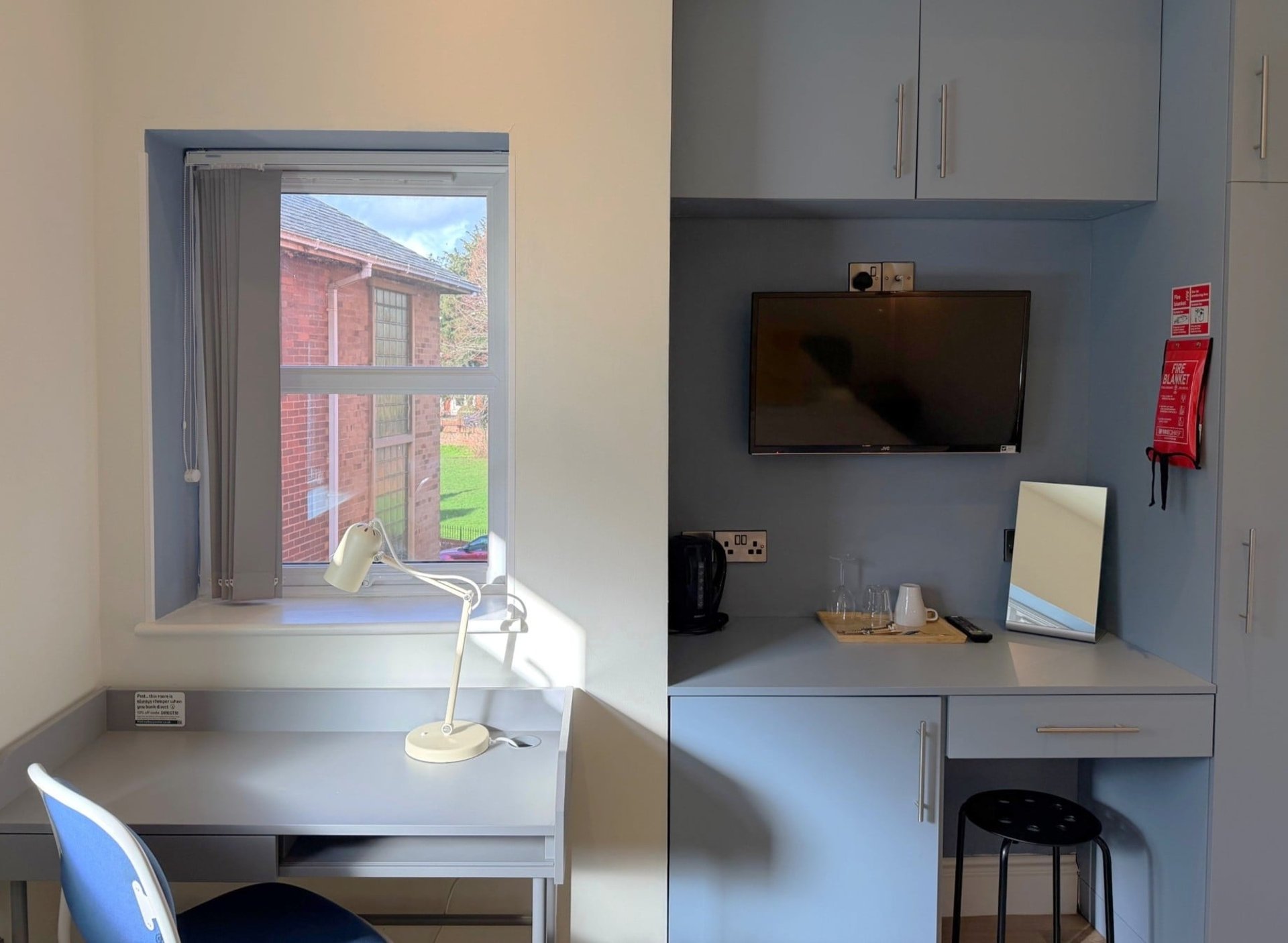 Desk in a room with a lamp